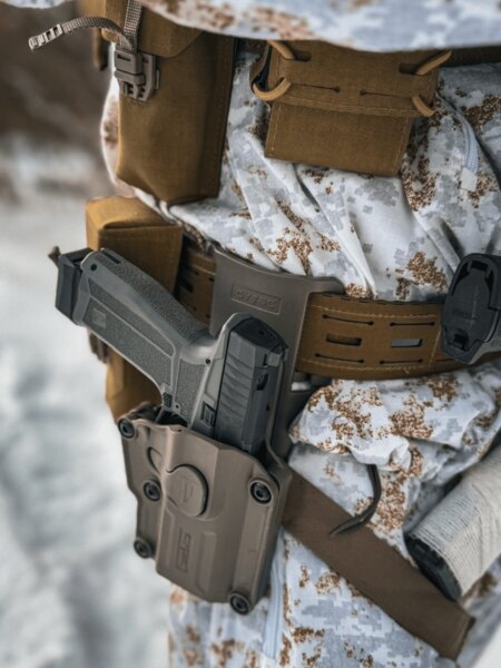 Low-ride belt holster with retention; weapon below belt level without a large thigh panel. Photo: Rigad