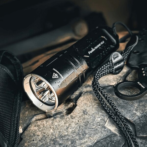Powerful waterproof Fenix LED flashlight on a wet surface – ideal for tough conditions. Photo: Rigad