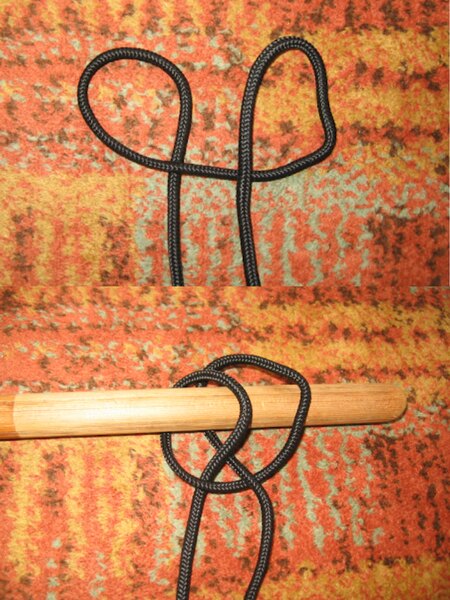 Demonstration of tying a clove hitch with black cord—forming two loops and securing it to a wooden pole.