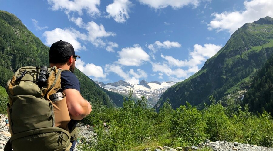 Man on a hike with a fully packed backpack 
