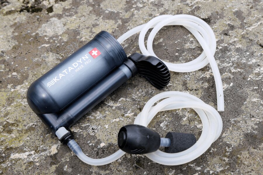 Katadyn Hiker Pro pump water filter with hoses placed on a rock. Photo: Rigad