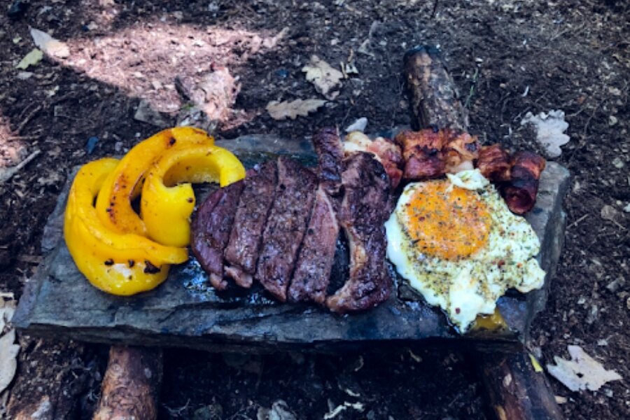 Outdoor cooking - steak on a stone