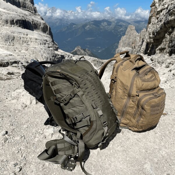 Two durable outdoor backpacks on a rocky mountain saddle overlooking the valley. Source: Rigad