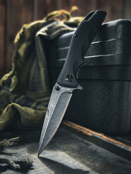 Fox Edge® folding knife with a stonewashed blade resting on a black case. Photo: Rigad