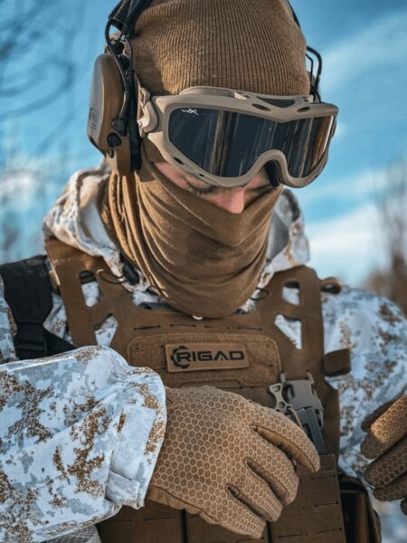 Operator in winter gear with hearing protection and tactical goggles; demonstrating compatibility of goggles with headset and helmet. Photo: Rigad