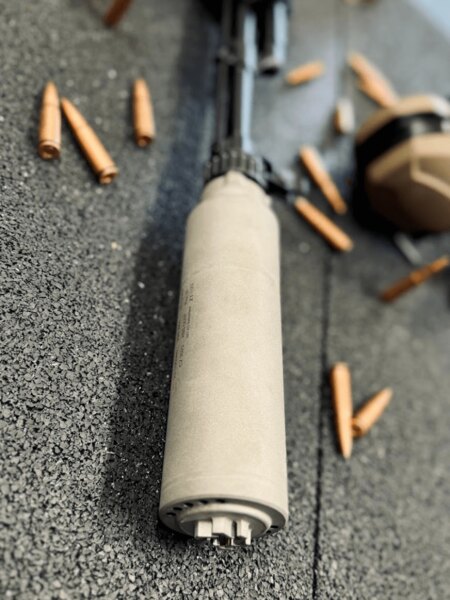 Suppressor on a long firearm with ammunition – modern suppressors for tactical and hunting use. Photo: Rigad