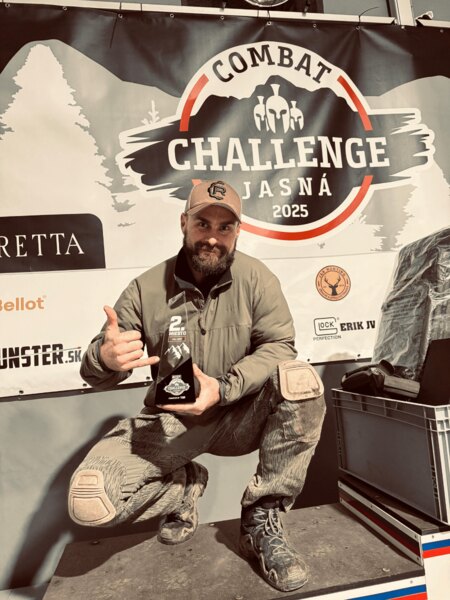 Martin Firych at Combat Challenge Jasná 2025 with the trophy for 2nd place in front of the official banner. Photo: Rigad
