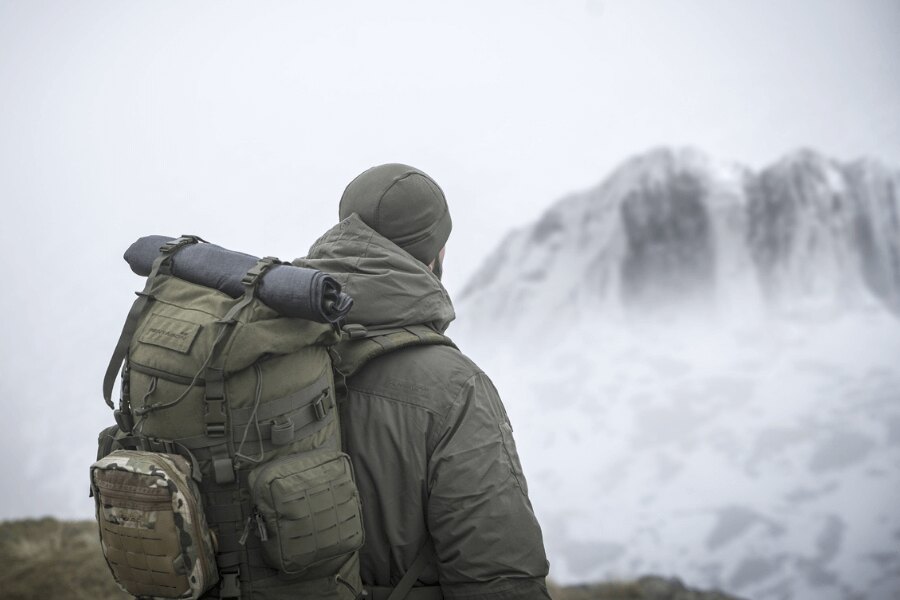 Outdoor backpack in the field during winter fog – an example of equipment that needs to be cleaned, impregnated, and properly stored before being put away. Photo: Rigad