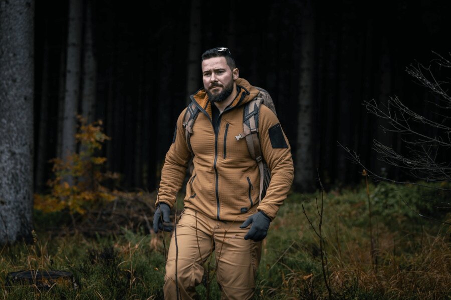 Man in a Helikon-Tex Patriot Pro sweatshirt during a forest march – showcasing the lightweight and wind-resistant Stormfleece® construction. Photo: Rigad