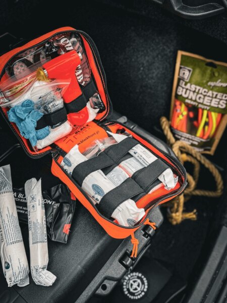 Open Blackfront first aid kit with organized storage of medical supplies – bandages, tourniquet, gloves, and knife. Photo: Rigad.