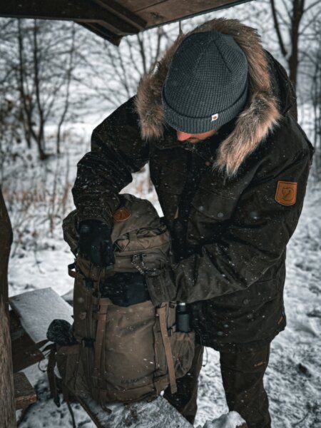 Robust expedition backpack Fjällräven Kajka placed in the snow, ready for a winter multi-day trip. Photo: Rigad
