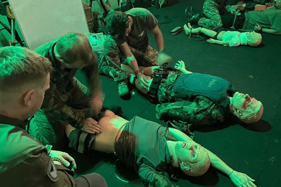 Tactical first aid training in a simulated stress environment – participants practice massive hemorrhage treatment on mannequins. Photo: Elite Centers