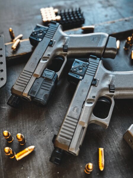 Glock 45 Gen6 A-CUT pistol with an Aimpoint COA red dot sight on a table with ammunition. Photo: Rigad