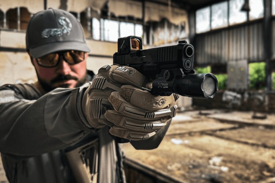 Shooter with a Glock 45 Gen6 pistol featuring an A-CUT slide modification and an Aimpoint COA red dot sight. Photo: Rigad