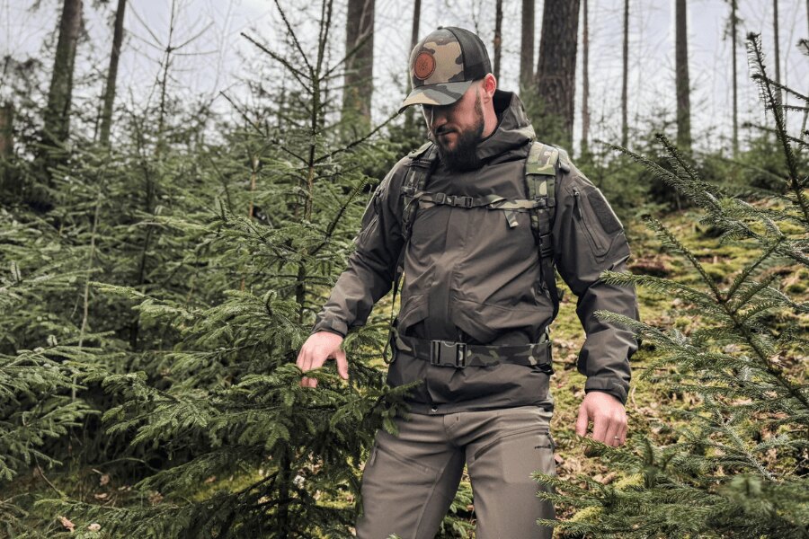 Man in a Helikon-Tex<sup>&reg;</sup> Chinook Waterproof Jacket Walking Through the Forest with a Backpack. Photo: Rigad