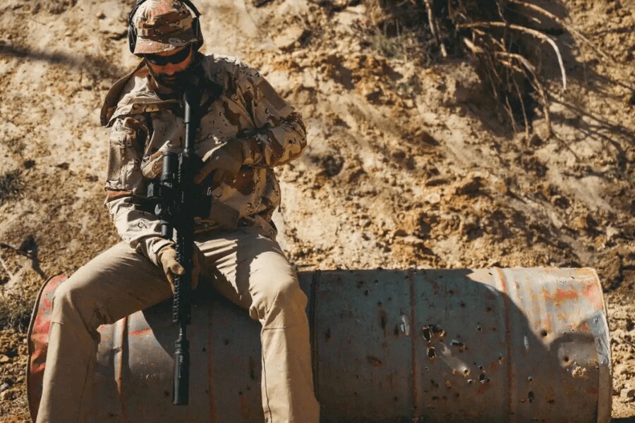 A shooter wearing Helikon-Tex 6-Color Desert camouflage during training in a desert environment.