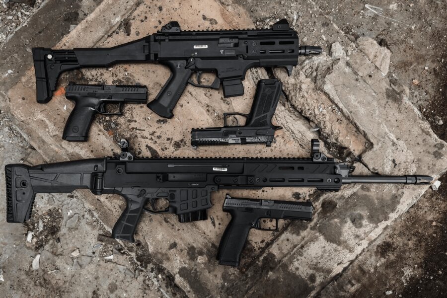 CZ Scorpion EVO 3 and handguns displayed on concrete blocks during a product photoshoot