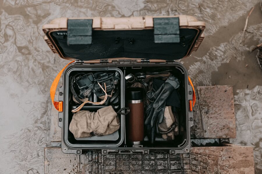 YETI LoadOut GoBox gear case loaded with equipment in wet outdoor conditions