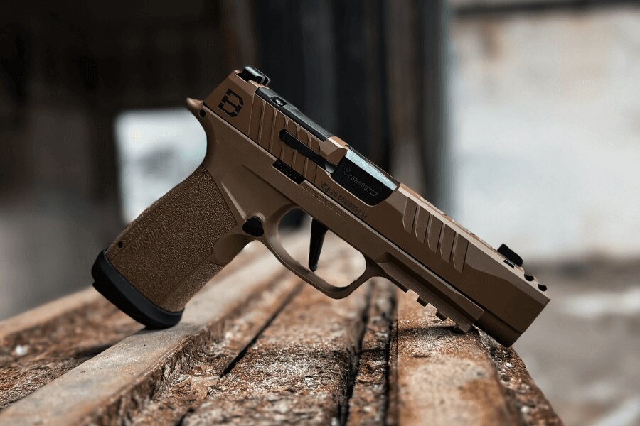 Modern semi-automatic pistol chambered in 9mm Luger resting on a wooden surface.