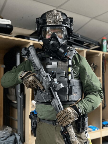 A tactical operator wearing a Busch PROtective helmet, protective mask, and mission-essential equipment. Photo: Busch PROtective