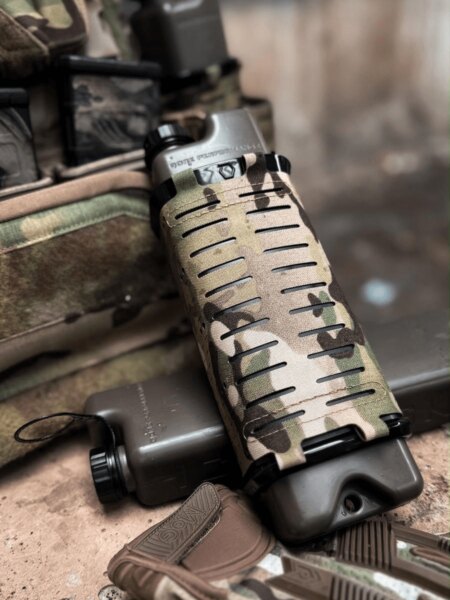 Qore Performance ICEFLASK<sup>&reg;</sup> carried in a MOLLE pouch mounted on a plate carrier.