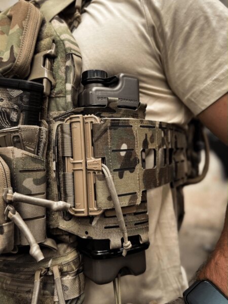 Qore Performance ICEFLASK<sup>&reg;</sup> mounted in a side pouch on a plate carrier as a hydration and thermoregulation system.