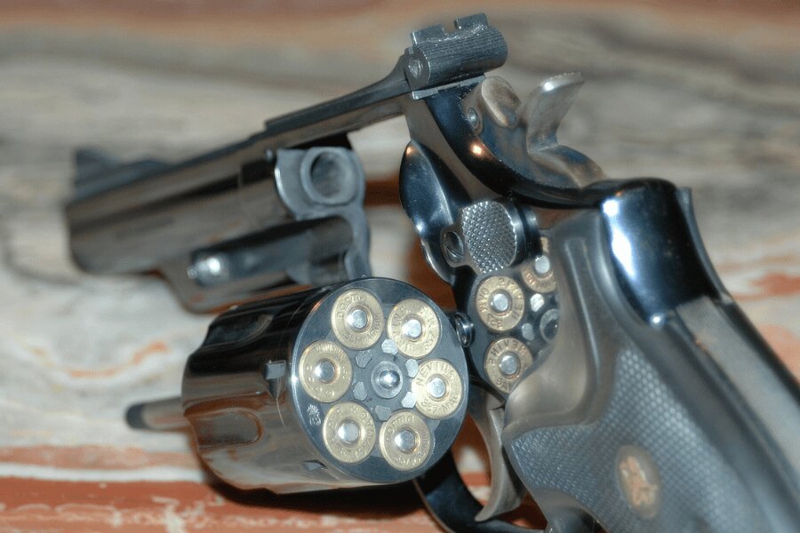 Smith &amp; Wesson Model 19 revolver with the cylinder open and loaded with .357 Magnum cartridges.