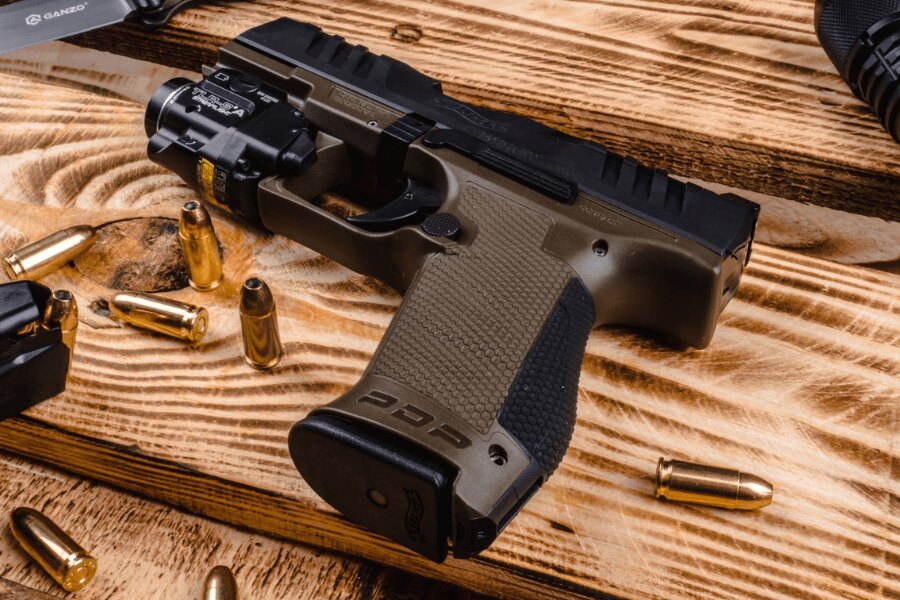 Walther PDP Compact pistol with adhesive grip tape and a Streamlight TLR-7A weapon light.