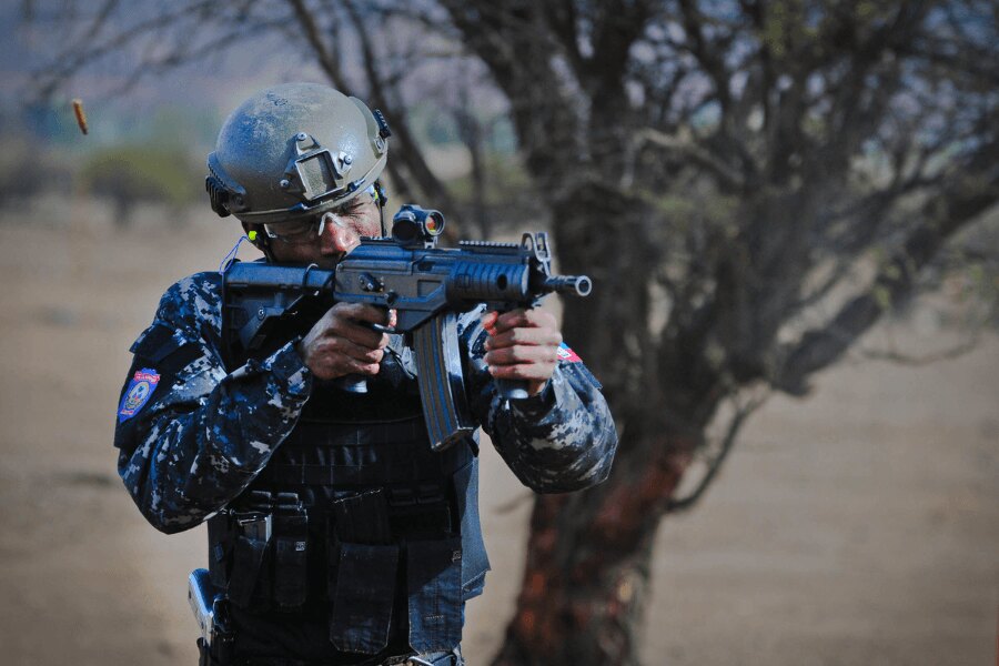 Service member firing an IWI Galil ACE rifle.