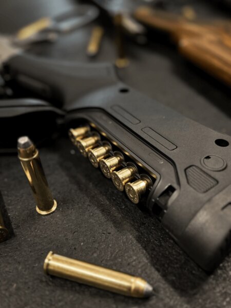 Close-up of a rifle stock with an integrated cartridge holder.