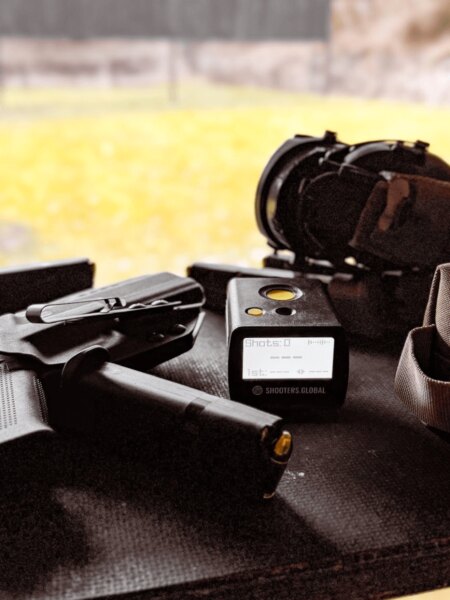 Handgun, magazines, Shooters Global shot timer and hearing protection ready for a training session.