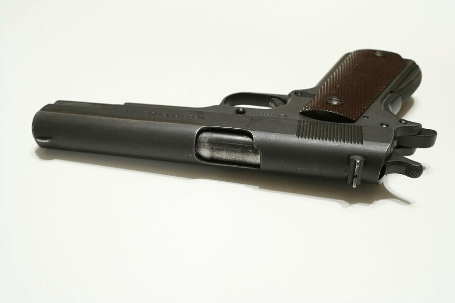 Historic Colt M1911 pistol manufactured in 1917, top view of the slide and grip.