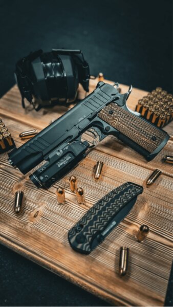 BUL 1911 EDC 5" pistol in .45 ACP with a Streamlight TLR-1 HL weapon light, ammunition and shooting gear.