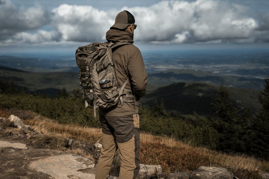 Man wearing a Wisport SilverFox 2 backpack in mountainous terrain.