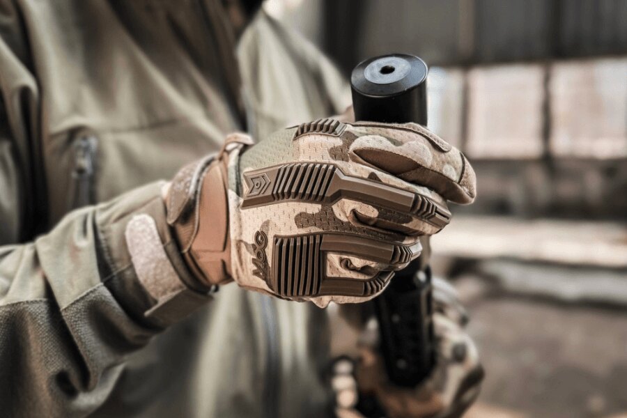 MoG Frog 1.5 tactical glove while handling a suppressor-equipped pistol.