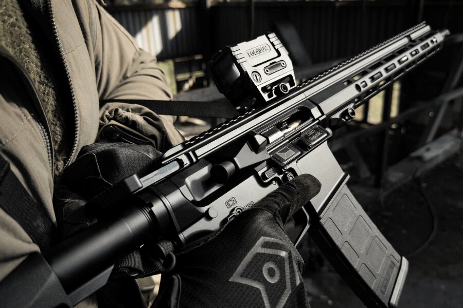 Antreg ARS M4s rifle fitted with a Holosun red dot sight, held by a shooter wearing black gloves.